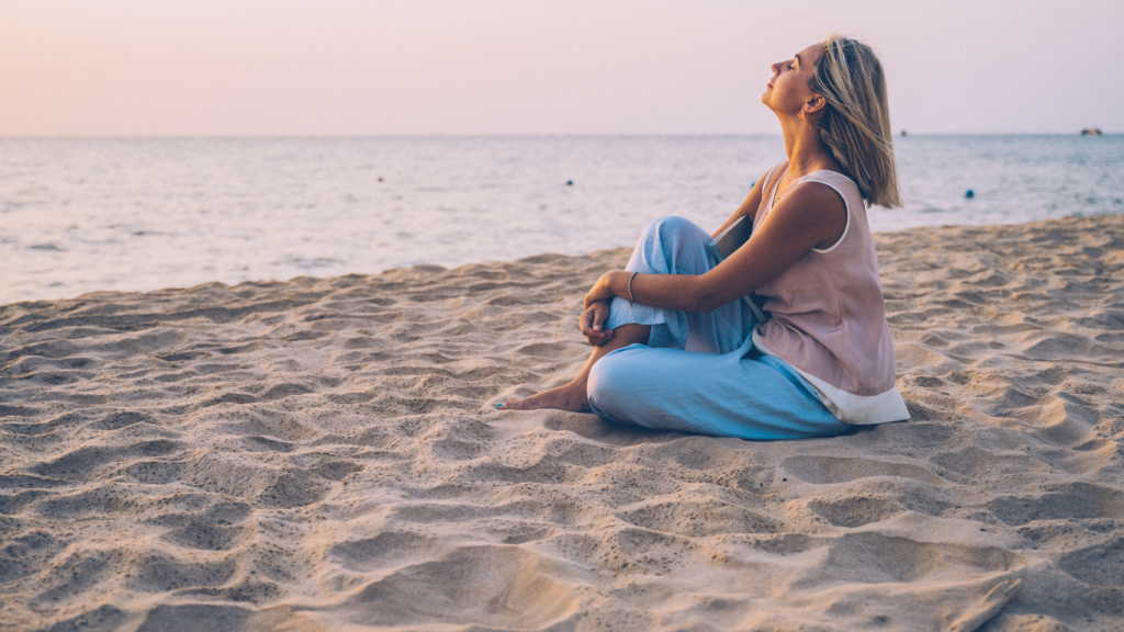 A women resting peacefully on the beach near sunset. Represents life when you get out of high alert and can relax.