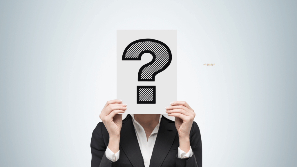 Image of a women holding a paper question mark in front of her face representing uncertainty about her identity with chronic pain.